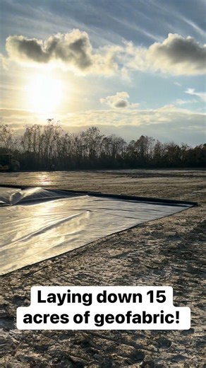 Rolling out 15 acres of geofabric for this laydown yard! | Asher Construction