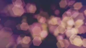 Download Abstract bokeh background animation with gently flickering defocused warm bokeh light hexagons. This elegant motion background is full HD and a seamless loop. for free