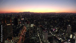 TOKYO, JAPAN : Aerial high angle sunset or sunrise view of CITYSCAPE of TOKYO and MOUNT FUJI. View of buildings and street around Shibuya. Japanese city life and nature concept 4K video.