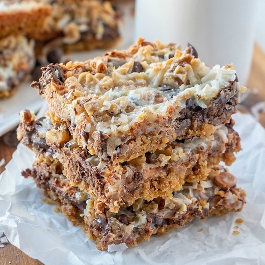 Seven Layer Magic Bars are to die for! A graham cracker crust, layers of chocolate, butterscotch, coconut, and more! These are SO GOOD! GET THE RECIPE---->>> https://belleofthekitchen.com/seven-layer-magic-bars/ | Belle of the Kitchen