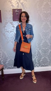 6.7K views · 130 reactions |  When the Sun Shines wear a Sun Dress  Navy Sun dress €45 Denim jacket €45 Orange Messenger Bag €45 Nero Giardini Leather Tan Sandals €170 #sundress #leathersandals #denimjacket | Klassy Lady | Facebook