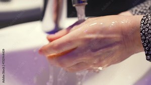 Hygiene concept.personal care and hygiene.prevention of protection against virus.person washes his hands with foam under tap.prevention of protection against virus.palms with soap under running water