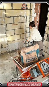 Spray plaster machine applying 15 kg mix During wall finishing work