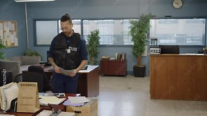 Police officer at his desk working with documents