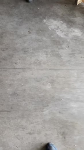 Walking on a Concrete Floor in Black Sandals