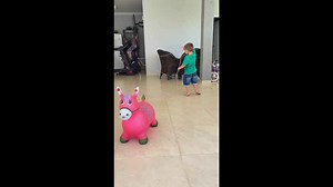 Little boy practicing lasso with toy horse in Brazil