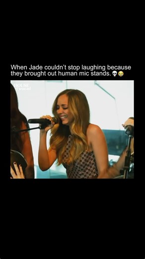 House of Vocal on Instagram: "The iconic performance of Little Mix singing “Black Magic” on the Hamish & Andy show, where they brought out human microphone stands—fans holding mics for the girls. Jade Thirlwall absolutely lost it, cracking up mid-performance because the setup was just too hilarious. Her laughter is so contagious in that clip! The way she tries to keep it together but just *can’t* is peak Jade energy. It’s from a 2015 appearance where the group was promoting their hit single “Bla