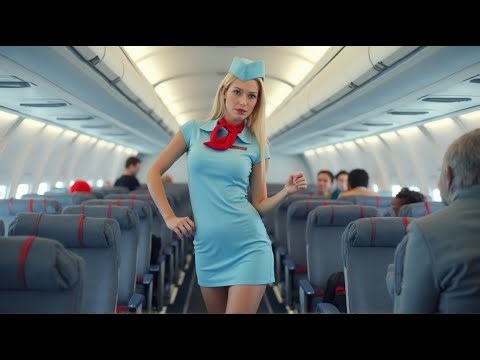 The beautiful flight attendant and the lucky man in the passenger cabin