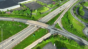 High aerial, top down view of highway interchange. View of on and off ramps of highway in America. Drone tilt down of traffic on USA roads.