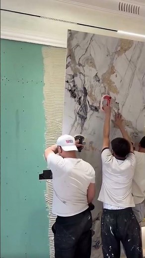 the process of installing very large granite tiles on the walls of a building #construction #shorts