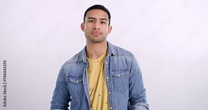 Frustrated, waiting and face of man in studio annoyed with conflict or problem in mockup background. Angry, person and disappointed with gossip, fail or bored emoji for disagreement and argument
