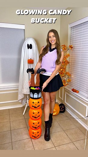 Kaitlyn Anderson on Instagram: "GLOWING CANDY BUCKET 🎃🍫🍭 This easy DIY will hold all your Halloween candy and double as the cutest decor to set out on your front porch or keep in the entry way! 🔗 LINKED everything on my LTK & Amazon Storefront! SUPPLIES: -4 pumpkin pails -1 candy bucket -Pliers -Hot glue gun -Box cutter -Orange string lights -Candy *Optional: Toppers to candy bucket- I used witch legs but you could use anything here (sign, dead tree limbs, skeleton bones, any Halloween decor