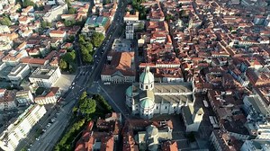 Aerial view of Como Cathedral which is seat of Bishop and is dedicated to Assumption of the Blessed Virgin Mary it is located near the lake and one of most important buildings in the region 4k