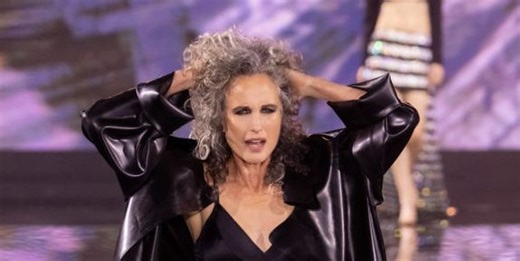 Andie MacDowell showcases her natural silver curls on the catwalk