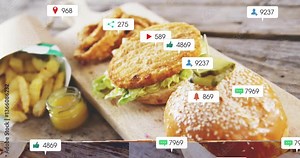 Animation overlay with social media icons on crispy chicken burger and fries