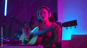 Social media sharing concept. Asian woman musician live streaming online guitar class with smartphone. Female guitarist making video lessons and tutorials for internet vlog website classes. Stock Video