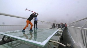 China's giant glass bridge hit with sledgehammer