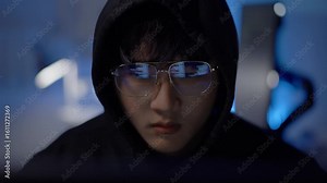 Hacker intensely coding during cyber operation, highlighting cyberattack, hacking, and system infiltration activity.