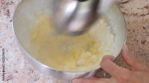 Cake preparation. The cake dough is mixed using an electric hand mixer.