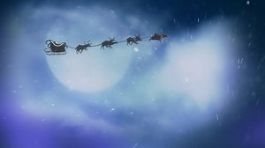 Santa Snowfall Particles Merry Christmas 4K features a clouded full moon with a silhouette of Santa flying and moving down to show a snowfall revealing a Merry Christmas message.