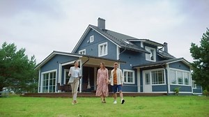 Real Estate Agent Showing a Beautiful House to a Young Happy Couple. People Walking Outside on a Lawn, Talking with Businesswoman, Discussing Buying a New Home. For Sale Sign on the Street.