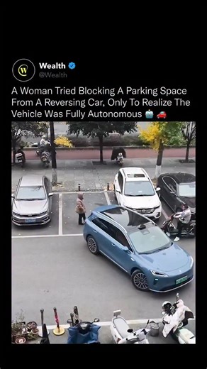 Wealth on Instagram: "Autonomous driving is advancing so quickly that people still struggle to recognize when a vehicle is operating without a human at the wheel. 🤖⚡️ In this situation, a woman attempted to block a reversing car, assuming a driver was trying to take the space. Only after stepping in front of it did she realize the vehicle was executing a fully autonomous parking sequence. Modern self-parking systems combine ultrasonic sensors, radar, multi-camera arrays, and real-time mapping t