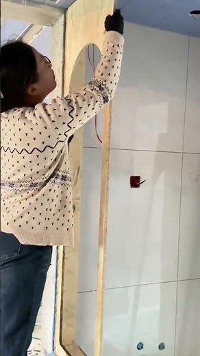 the process of installing wood to make a window frame on a wall