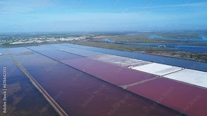 Aerial drone view of Salt production in the evaporators of sea salt in nature reserve Marismas del Odiel. Traditional Sea salt production produced by the evaporation of seawater.