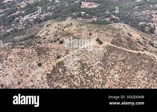 Valley with rarely growing trees and dry grass, aerial view