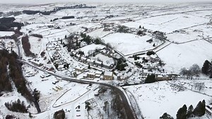 Drone footage shows snow-covered village