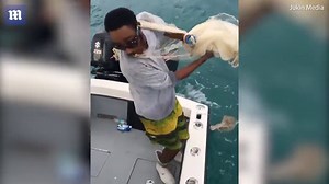 Fisherman attempts to throw net off boat but falls in the water