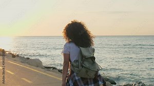 Young woman skating on a skateboard on a beach coastal alley at Sunrise. Girl riding long board, HDR 4K, Slow motion.