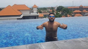 Adult Male Enjoys Action-Packed Rooftop Pool Moments