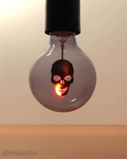 physicsfun on Instagram: "Neon Flicker Flame Skull Bulb: no flame but instead emission spectra from excited neon gas due to the presence of a discharge electric current. A dual axis diffraction grating creates a dramatic effect and shows that neon only emits light in specific wavelengths of reds and yellows at AC house voltages. 💀 Happy Halloween! 🎃 ➡️ Follow the link in my profile for info on where to get similar bulbs and other amazing items featured here on @physicsfun #neon #
