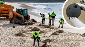 Workers clean up Coogee Beach after it was closed due to some unidentified pollution