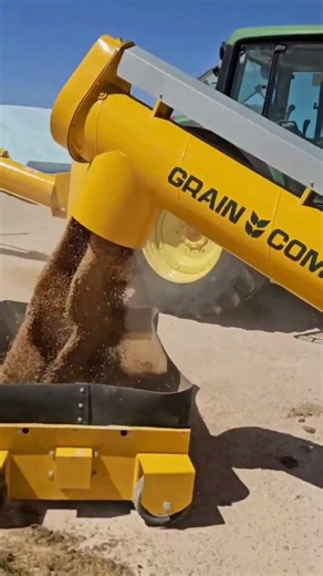 Grain unloading using a drive-over grid and swing-away auger, shown here in action. #farming #grain