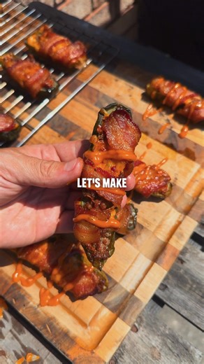 Level up your tailgate with these cheeseburger pickle poppers wrapped in bacon. Recipe: -Cut whole dill pickles in half and core out the seeds with a spoon. -Fill with a layer of cooked and seasoned ground beef, top with shredded cheese, and wrap in a slice of bacon. -Place on a wire rack for easy transfer and cook indirect at 300F for 45-60 minutes or until the bacon is crispy. -Remove and rest for 7 minutes for the bacon to solidify and top with burger sauce. | Kingsford