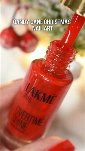 Lakmē on Instagram: "All I want for Christmas is nail art that slays ✨💅🏻✨ Here’s your easy 🍬 Candy Cane Nails tutorial for the Holiday Szn!🎄🎁 Products in focus: 👉 9To5 Overtime Shine Nail Paint in Ruby Rush 👉 Ultimate Glam Chome Nail Paint in Copper Shop Lakmē nail paints on @mynykaa, @tirabeauty and @myntra today! LAKMĒ (Lakme, Holiday, Nail Paints, Party Nails, Candy Cane Nail Art, Christmas Nails, Christmas 2025, Nail Art, Red Nails, Stripe Nails, Nail Art Inspo) #Lakme #Christmas #Nai