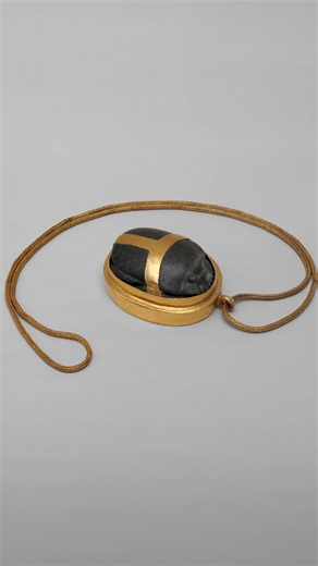 Over 3,500 years old, this serpentinite and gold heart scarab dates to Egypt’s 18th Dynasty. It shows detailed carving of the beetle and is fitted with a quadruple-link gold chain. The underside bears a version of Book of the Dead spell 30A, with Hatnefer’s name added over an earlier erased inscription, indicating it was repurposed rather than made specifically for her. It measures 6.6 × 5.3 × 2.8 cm (2 5/8 × 2 1/16 × 1 1/8 in), with a chain length of 77.5 cm (30 1/2 in). This artifact is now ho