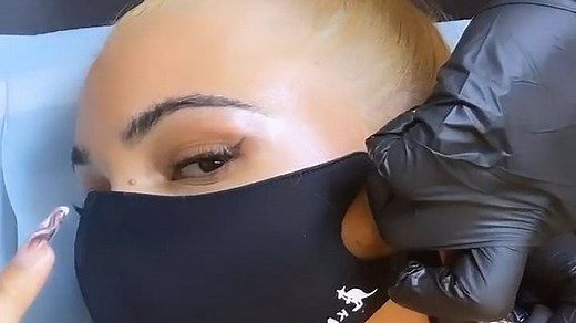Mabel wears face mask as she gets fresh tattoo