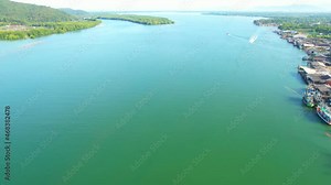 An island-shaped mangrove forest in the middle of a river mouth near the sea. shellfish farm around the mangrove forest. which is the way of life of the fishing community. Drone 4K shot.