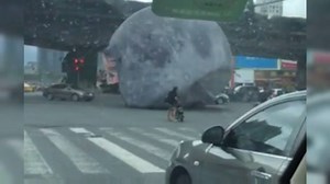 ABSOLUTE LUNACY: A giant, inflatable moon has bounced its way through the streets of Fuzhou in China, after it was blown free by strong winds from approaching typhoon Meranti. MORE DETAILS: http://www.9news.com.au/world/2016/09/15/10/03/giant-model-moon-bounces-across-chinese-streets/?ocid=9newsfb #9News | http://9News.com.au | 9 News