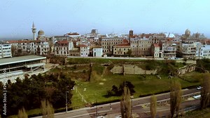 Lift aerial shot of Old Town Constanta, Romania, revealing the Roman Edifice with mosaique and the architecture of the ancient city Tomis