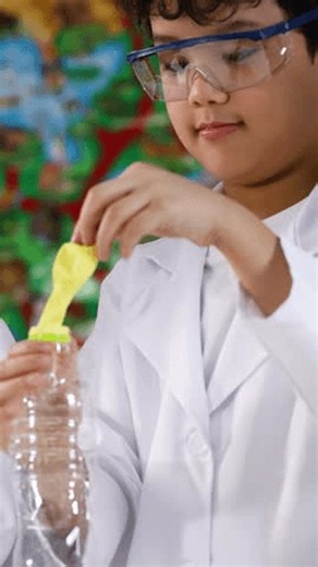 clip-4184131787-young-students-lab-coats-conduct-chemical-experiment