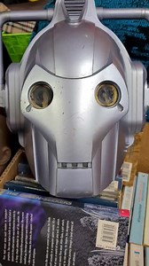 Talking Cyberman helmet from Dr. Who. When the battery compartment was opened there was old batteries with leakage and one battery was corroded to the spring. Managed to get it off without the spring being damaged, gave it a clean and popped in some new batteries with the hope it would be OK. Have found he has a really good range of phrases on one button and the sounds of battle on another and one that seems to do zilch, nada and nothing. I think it is a voice changer as the helmet has a microph