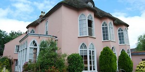 This pink thatched cottage in Devon is a lovely rustic home for sale