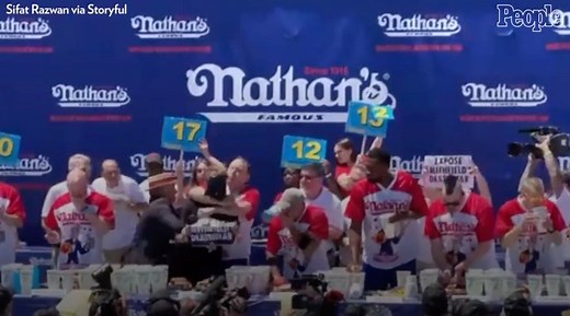 42K views · 602 reactions | Joey Chestnut fought off a protestor while competing in this year's Nathan's Annual Hot Dog Eating Contest. | People | Facebook
