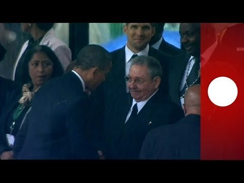 Historic handshake: Obama greets Cuba's leader Raul Castro at Mandela memorial