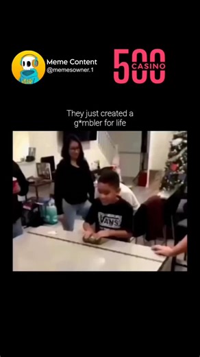 Funny Memes on Instagram: "This video captures a high-energy family game played during a holiday gathering, likely Christmas, given the festive decorations in the background. A young boy named Jojo is at the center of the excitement, participating in a game where he slides a weighted can down a long table. The table is lined with various prizes, including cash denominations like $10 and $20, several scratch-off lottery tickets, and a grand prize at the very end. The atmosphere is electric as fam