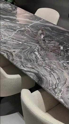 A dining table forged as a dramatic canvas of nature and precision.